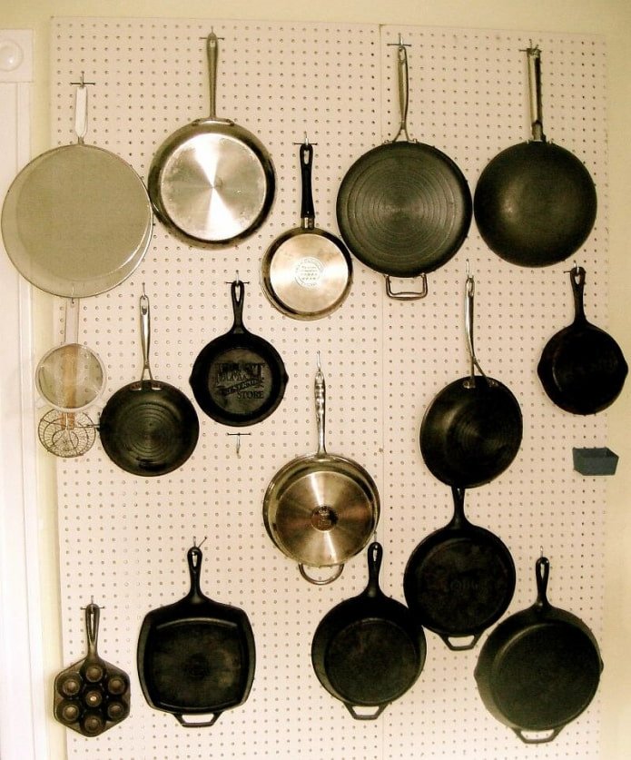 Frying pans on a board with perforation