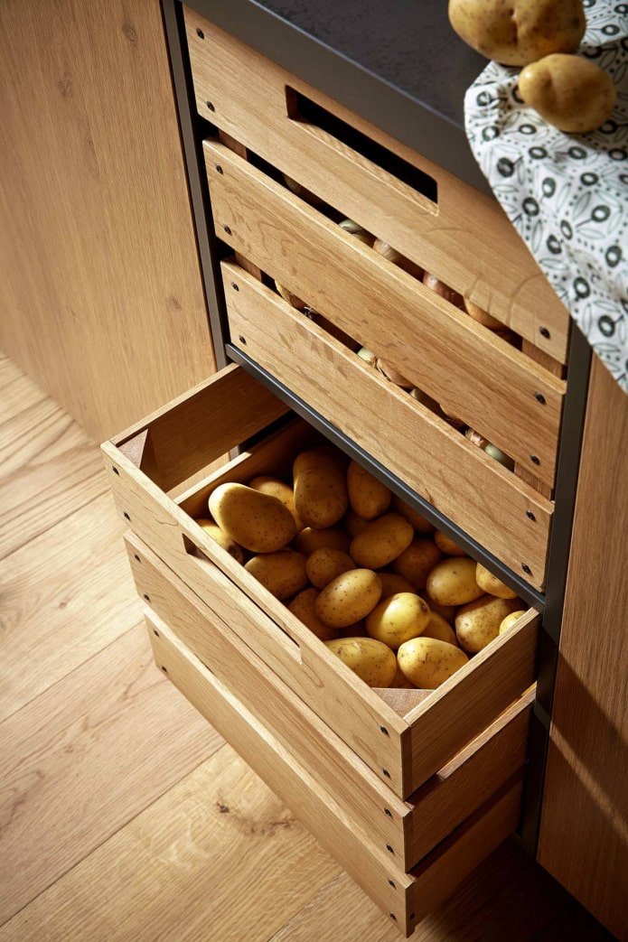 Potatoes in boxes in a cabinet