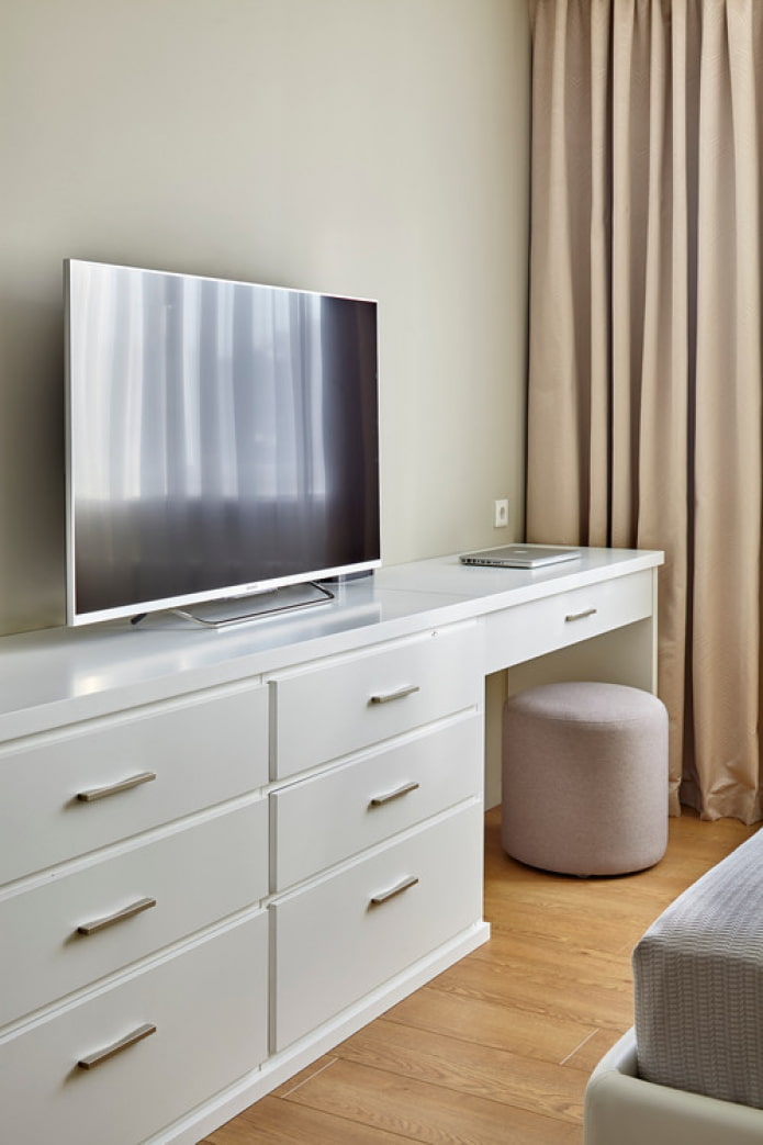 chest of drawers with a table for makeup