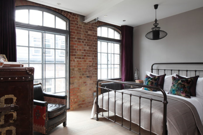 forged bed in a loft-style bedroom