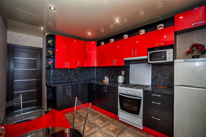 Red and black kitchen with a dark door