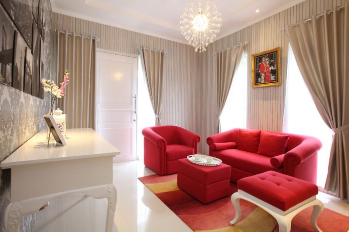 beige wallpaper and a bright red sofa