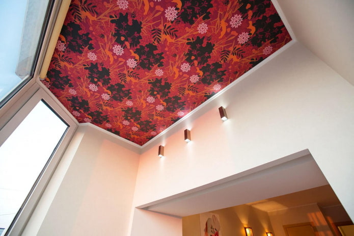 red wallpaper with a flower on the ceiling