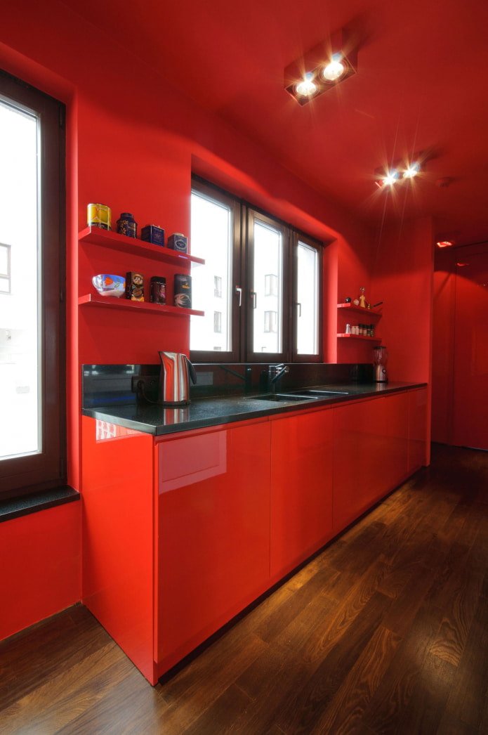 all-red kitchen with wooden floor