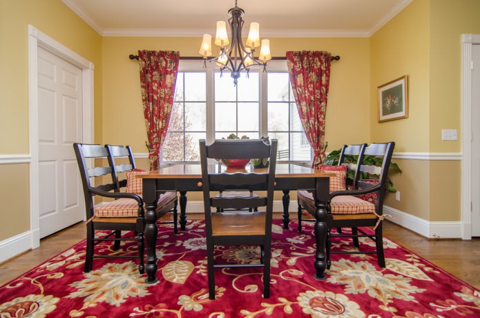red curtains and a flowered carpet