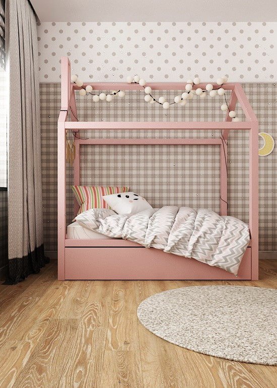 pink house-shaped bed in a nursery
