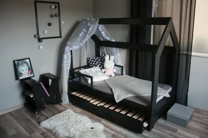 bed in the form of a house in the nursery