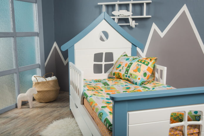 a house-shaped bed with sides in a child's room