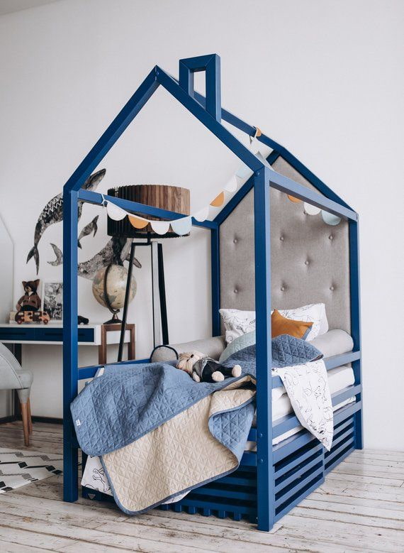 blue house-shaped bed in a nursery