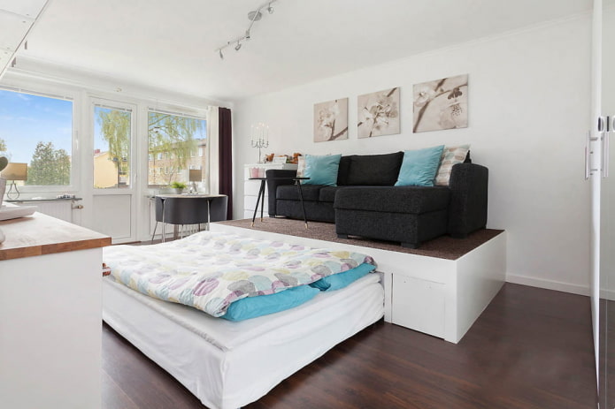 bed on a podium in the living room interior