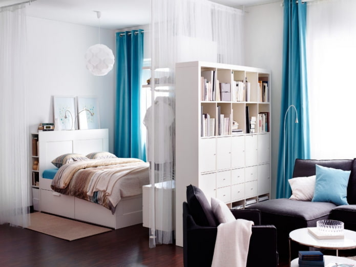 Bed separated by a chest of drawers