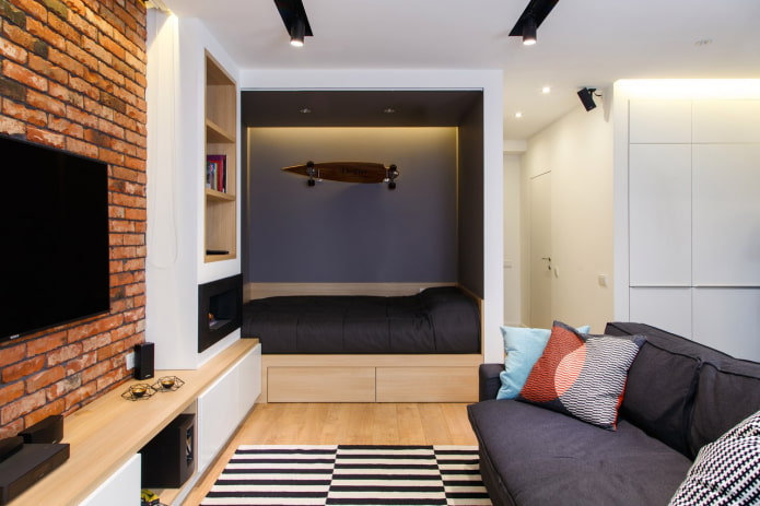 niche with a bed in a one-room apartment