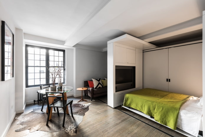 spacious one-room apartment with a bed