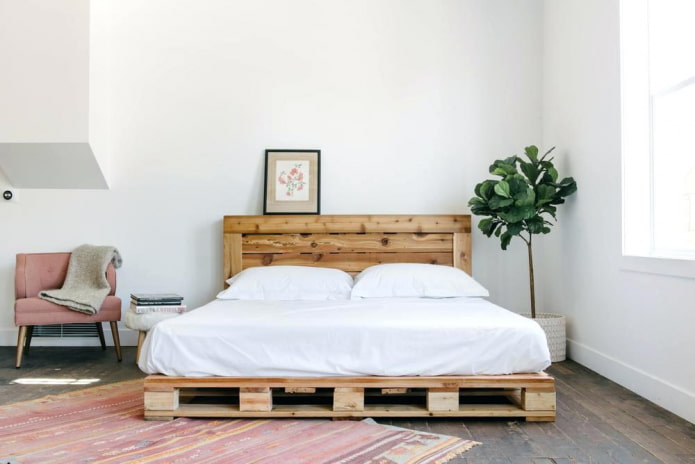 bed made of pallets in the bedroom interior