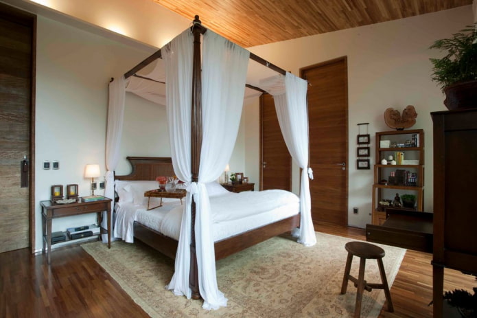 wooden bed with a canopy in the interior