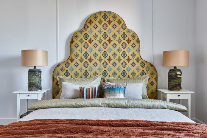 bed with a colored headboard in the interior