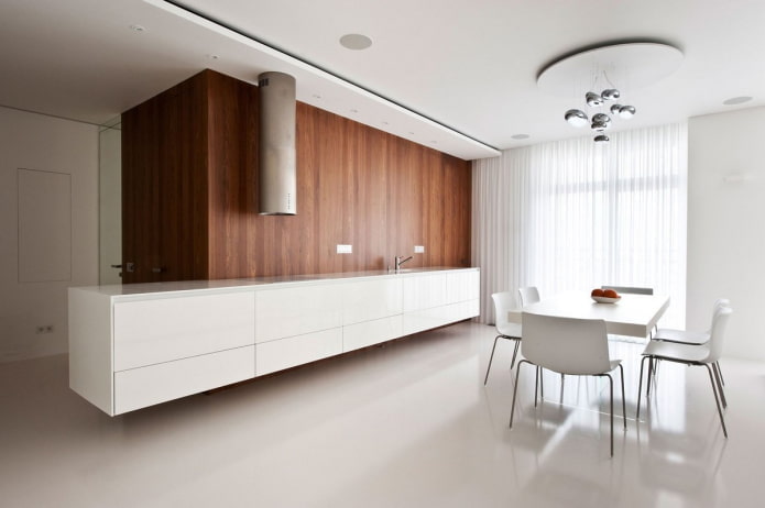 Wooden wall against the background of a white kitchen
