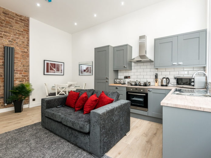 sofa in the interior of the kitchen-living room of 16 square meters