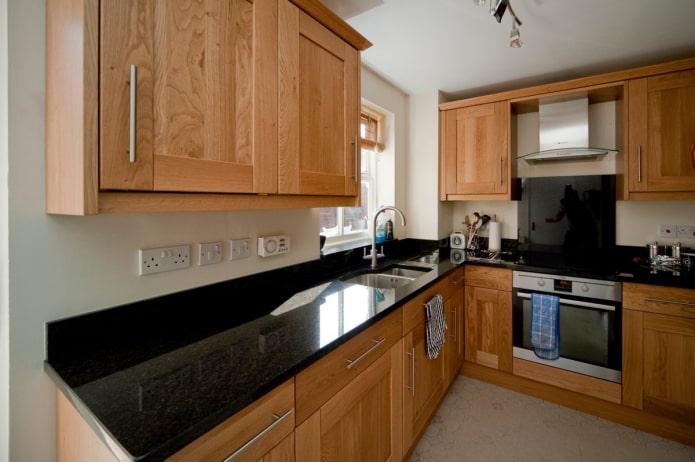 wooden kitchen with black countertop