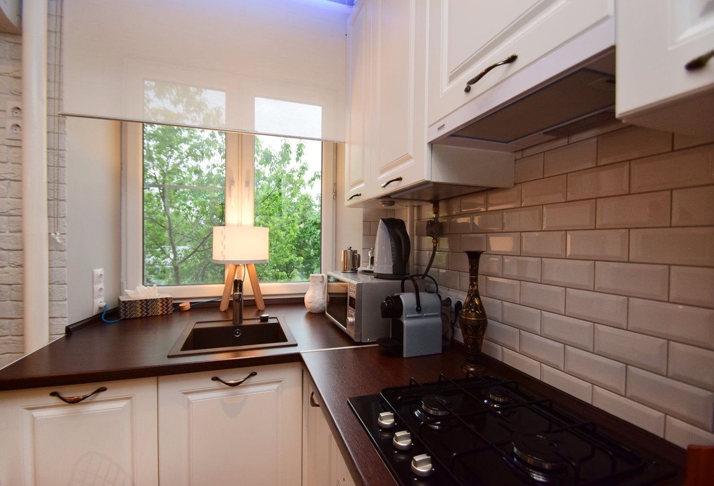 corner kitchen set with a sink under the window