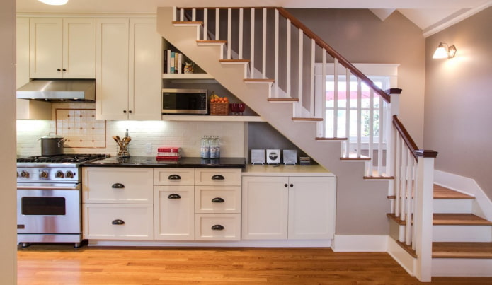 White kitchen under the stairs