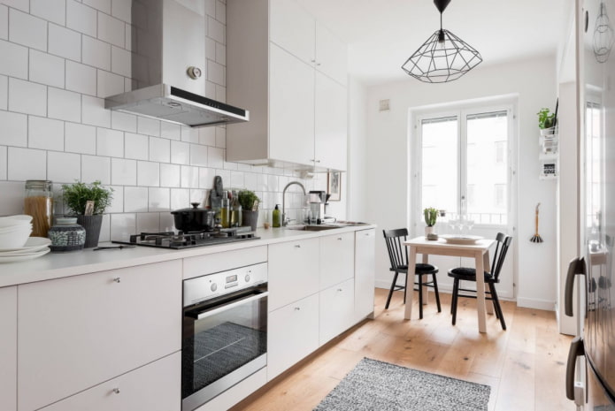 white kitchen with wooden floor