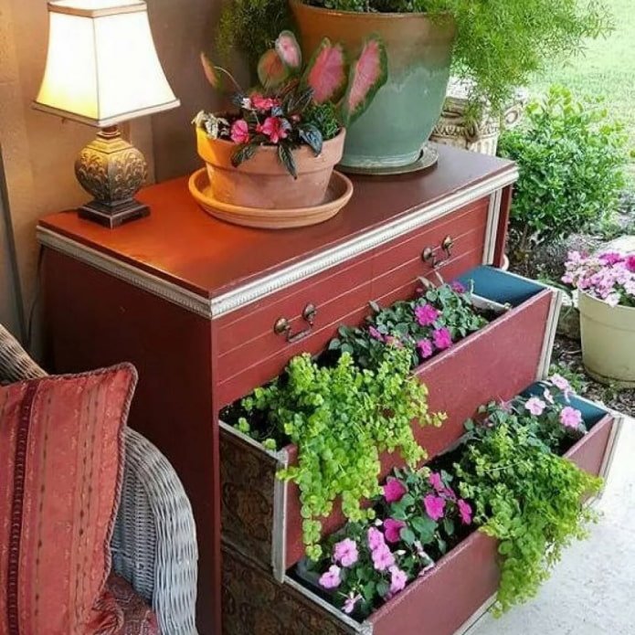 Chest of drawers with flowers at the dacha
