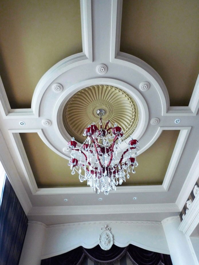 stucco decor on the ceiling under the chandelier