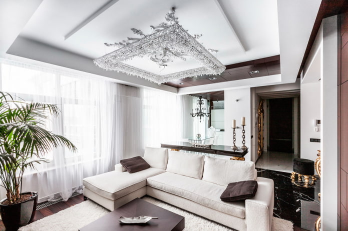 chandelier above the sofa in the living room interior
