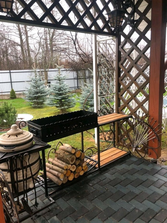 metal barbecue with a woodshed
