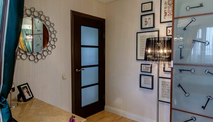 a combination of light wallpaper with a dark brown door with glass inserts