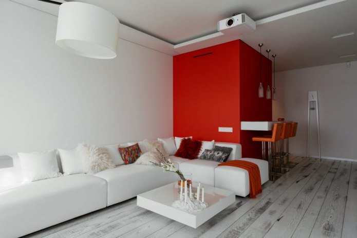 Bar counter in the interior of the kitchen-living room in white and red tones