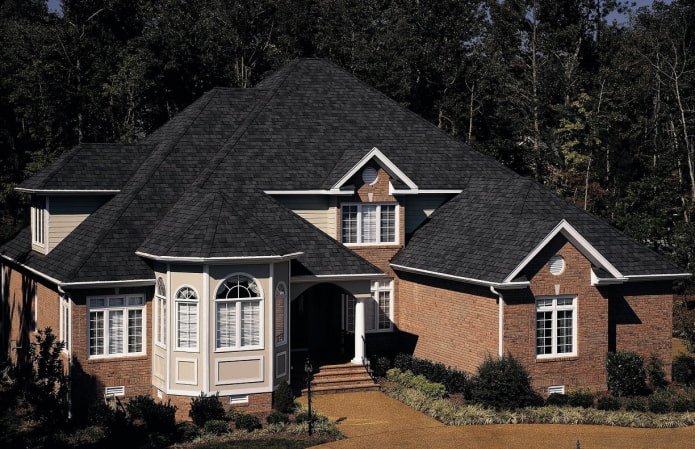 cottage with black soft roofing