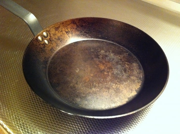 steel frying pan with carbon deposits