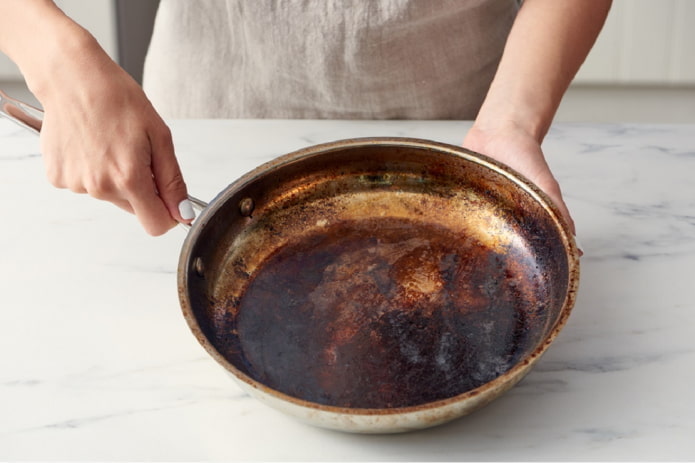 aluminum frying pan with carbon deposits