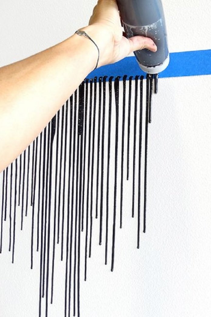 a stripe of black paint drips on the wall