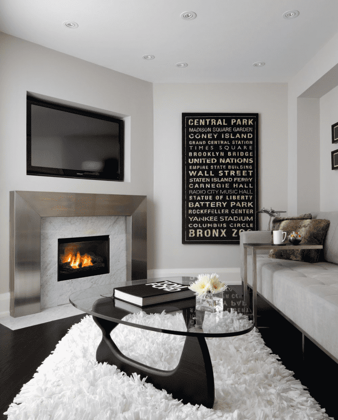 TV in a niche above the fireplace in the interior