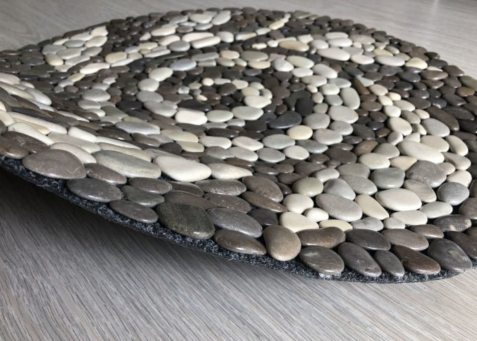 foot massage mat made of carpet and pebbles