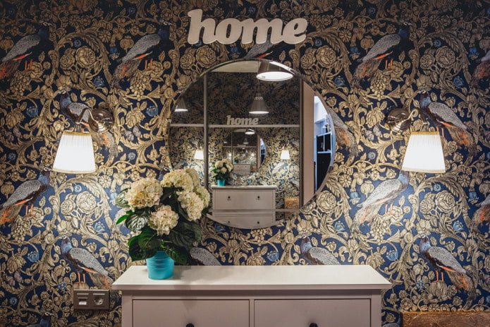 Blue wallpaper with a gold floral pattern and peacocks