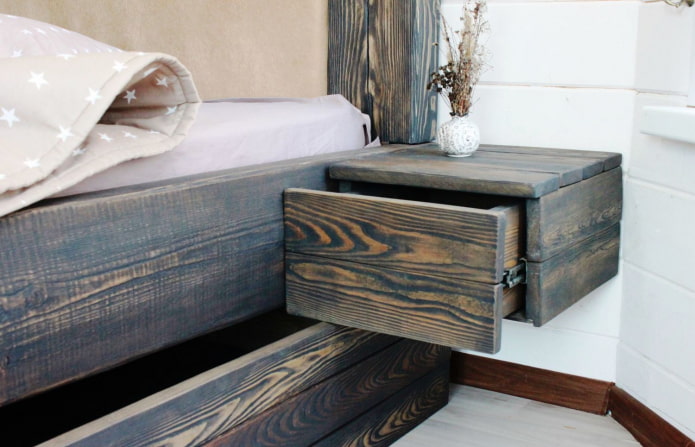 bed and night table made of charred wood