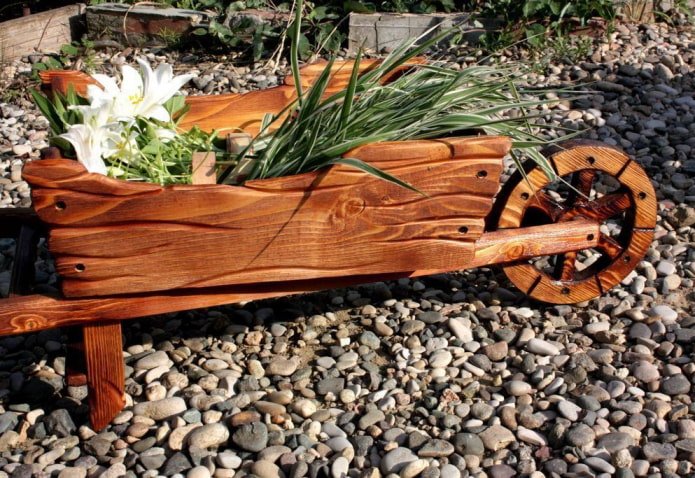 cart-shaped flowerbed made of burnt wood