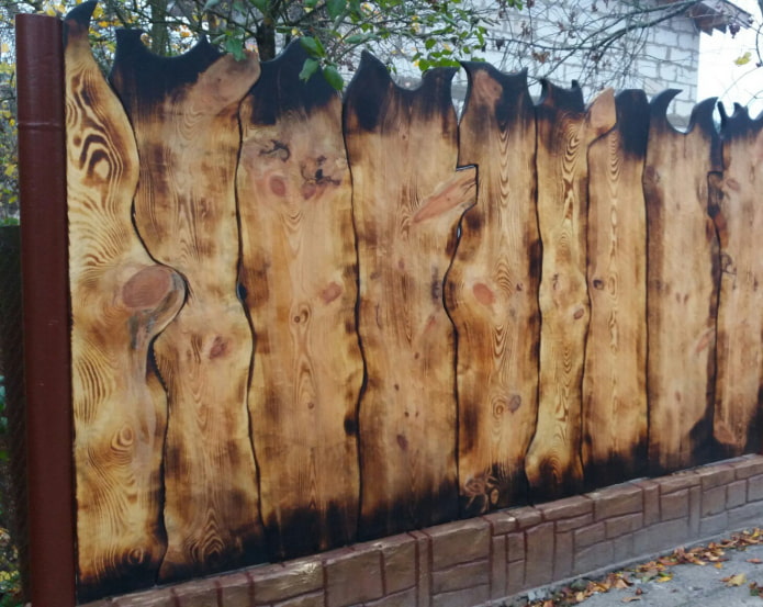 fence made of burnt unedged board