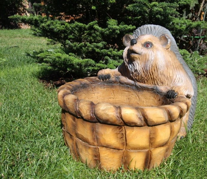 sculpture of a hedgehog with a basket made of burnt wood