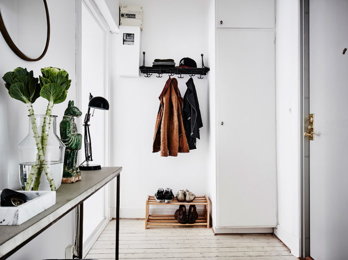shoe rack in the interior of the hallway in the Scandinavian style