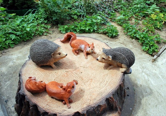 decorative lid of a septic tank with hedgehogs and squirrels