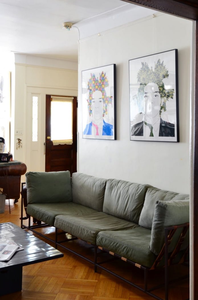 two posters above the sofa