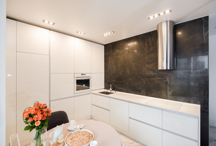 lighting of a stretch ceiling in the interior of a small kitchen
