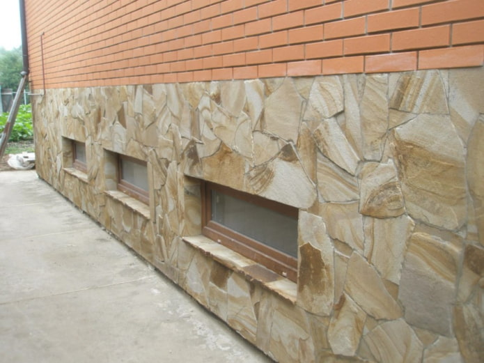 laying natural stone on the facade