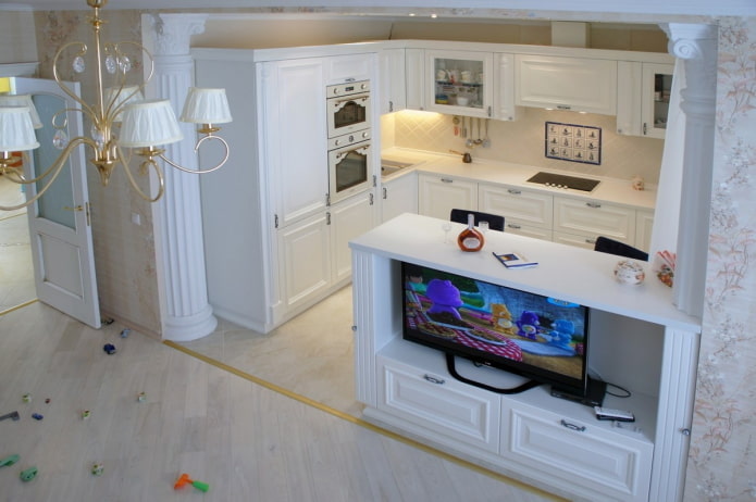 Kitchen with a TV in the bar counter