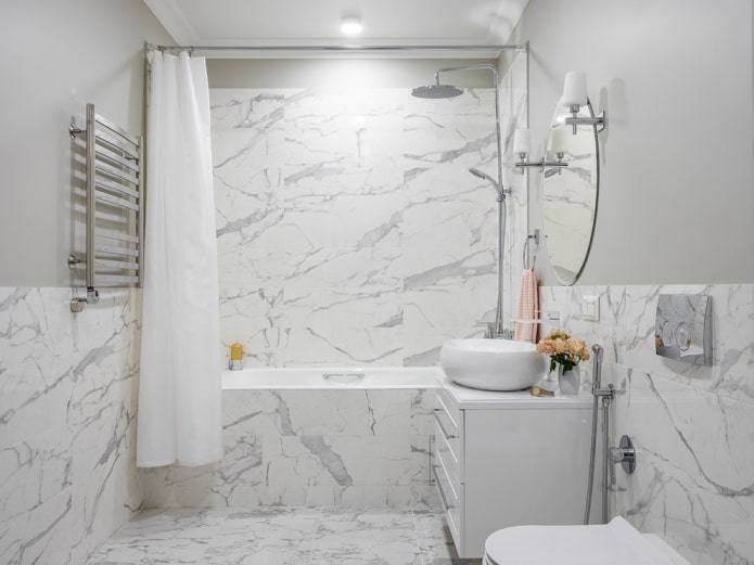 Marble tiles on half a wall and in the shower